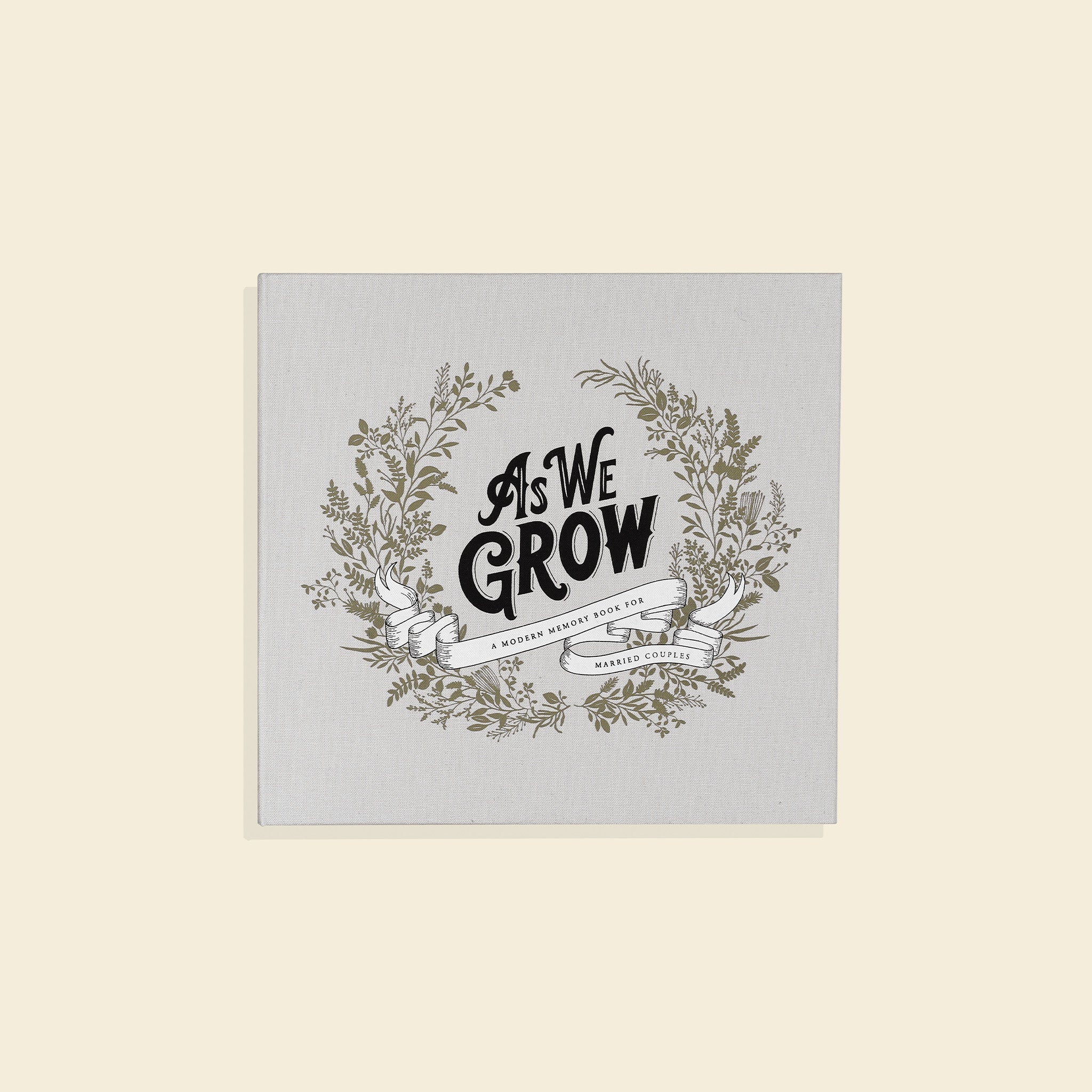 Decorative print with 'As We Grow' text and floral wreath on a light gray background