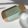 Box of Slow North bath bombs with a single bath bomb on a light background