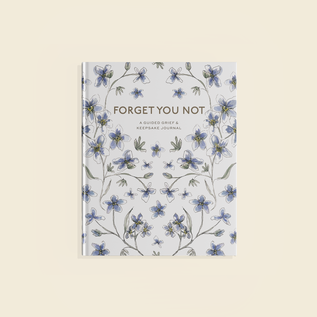 Journal with floral design and 'Forget Me Not' text on a light background