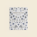 Journal with floral design and 'Forget Me Not' text on a light background