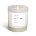 Candle labeled 'Of the Sea' by 'Slow North' on a white background