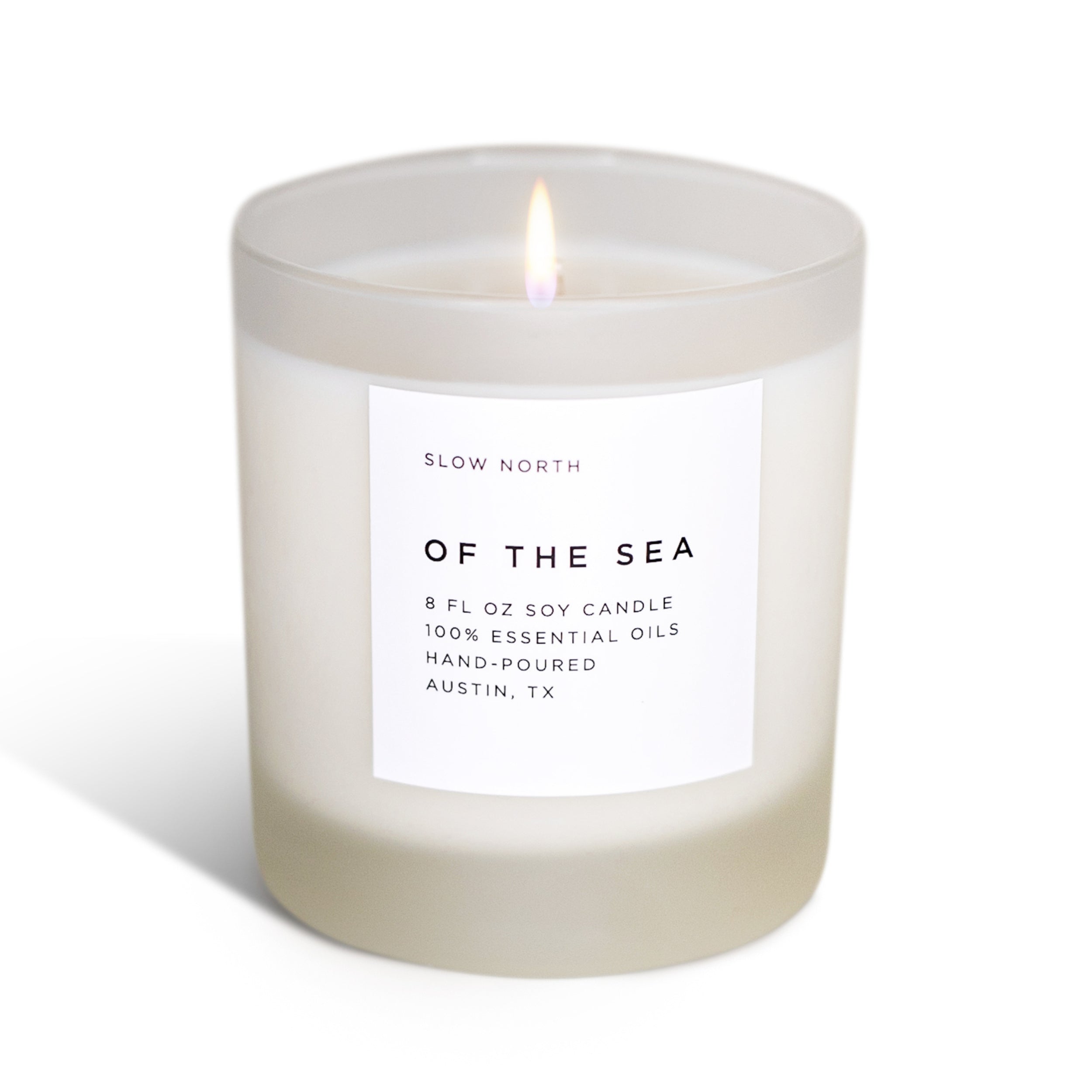 Candle labeled 'Of the Sea' by 'Slow North' on a white background