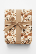 Gift box with floral pattern and dog images tied with a ribbon on a white background
