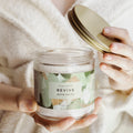 Person holding a jar of 'Revive' bath salts with a gold lid.